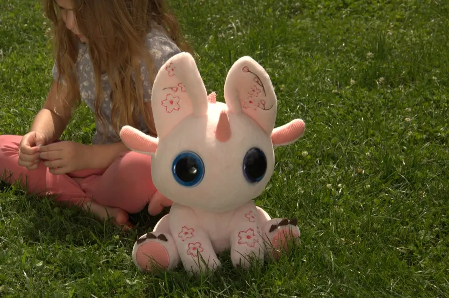 A child sitting comfortably beside Bloom.